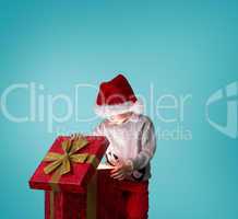 Composite image of festive boy opening gift