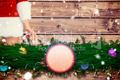 Composite image of pretty girl in santa outfit holding gift