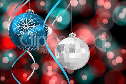 Composite image of hanging christmas bauble decorations