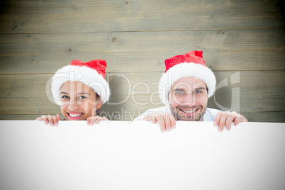 Composite image of festive young couple smiling at camera