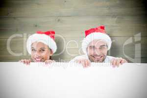 Composite image of festive young couple smiling at camera