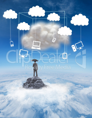 Composite image of businessman standing under umbrella