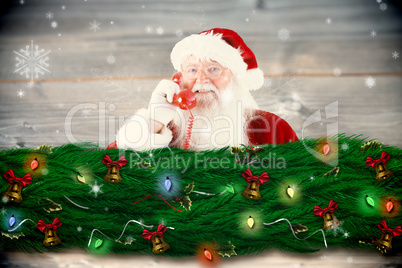 Composite image of santa claus on the phone