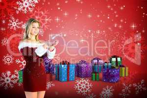 Composite image of pretty girl holding hands out in santa outfit