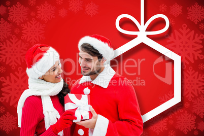 Composite image of festive young couple holding gift