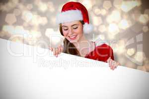 Composite image of pretty girl in santa costume showing card