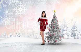 Composite image of pretty girl smiling in santa outfit