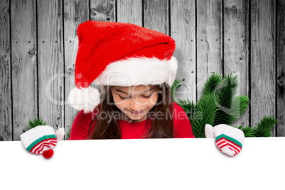 Composite image of festive little girl showing card