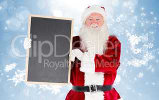 Composite image of santa claus showing blackboard