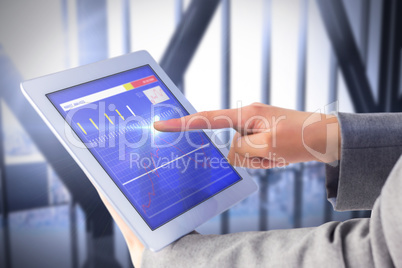 Composite image of businesswoman using a tablet pc