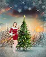 Composite image of pretty girl smiling in santa outfit