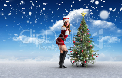 Composite image of sexy santa girl blowing a kiss