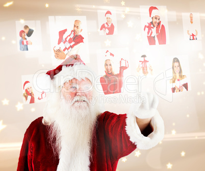 Composite image of santa pointing to christmas people collage