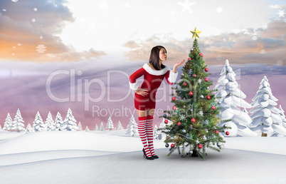 Composite image of pretty girl in santa outfit blowing