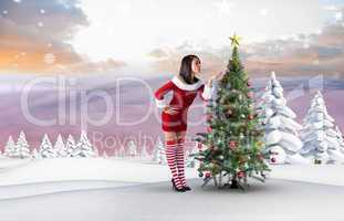 Composite image of pretty girl in santa outfit blowing