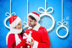 Composite image of festive young couple holding gift