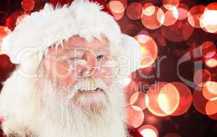 Composite image of santa claus winking