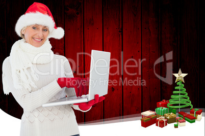 Composite image of festive woman holding laptop