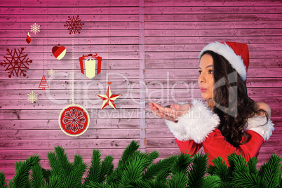 Composite image of pretty girl in santa outfit blowing