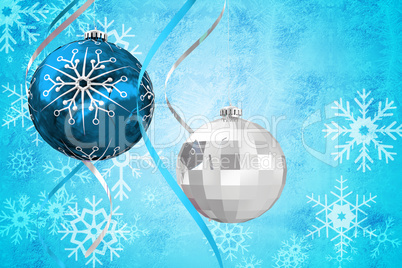 Composite image of hanging christmas bauble decorations