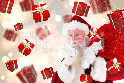 Composite image of santa claus carrying sack