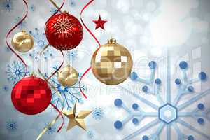 Composite image of hanging christmas bauble decorations