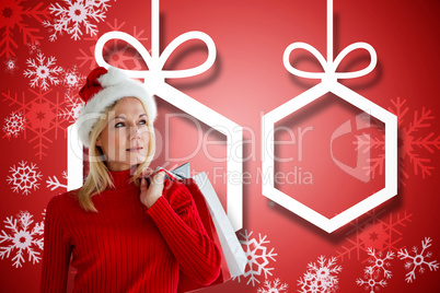 Composite image of happy festive blonde with shopping bags