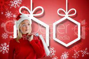 Composite image of happy festive blonde with shopping bags
