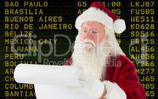 Composite image of santa claus checking his list