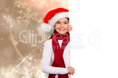 Composite image of festive little girl showing card