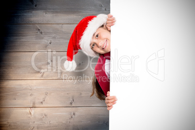 Composite image of festive little girl showing card Composite image of festive little girl showing card