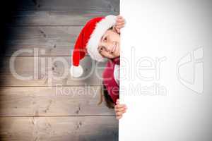 Composite image of festive little girl showing card