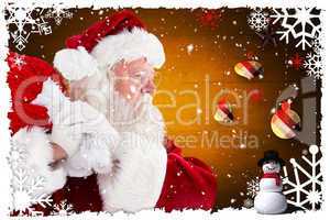 Composite image of santa claus carrying sack