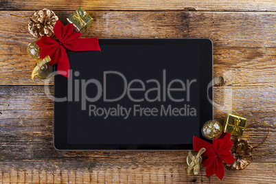 tablet pc with  christmas decorations on wooden background