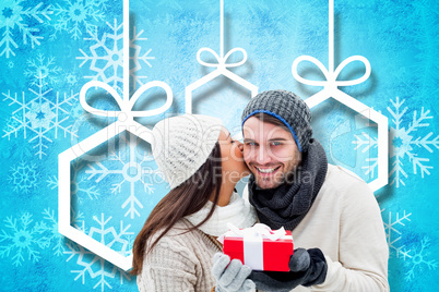 Composite image of winter couple holding gift