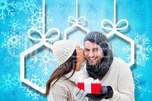 Composite image of winter couple holding gift