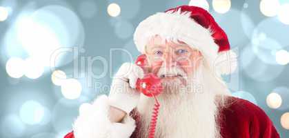 Composite image of santa claus on the phone