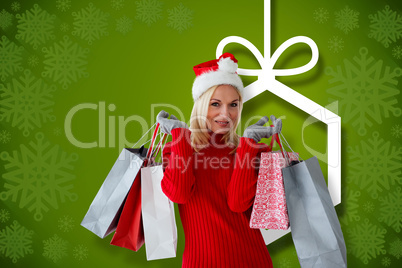 Composite image of happy festive blonde with shopping bags