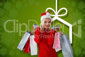 Composite image of happy festive blonde with shopping bags