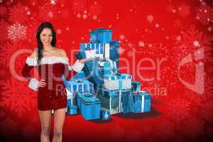 Composite image of pretty girl in santa outfit holding gift