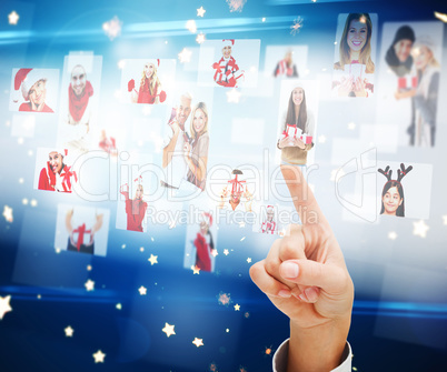 Composite image of hand pointing to christmas people collage