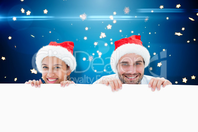 Composite image of festive young couple smiling at camera