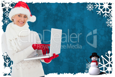 Composite image of festive woman holding laptop