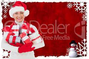 Composite image of festive woman holding gifts