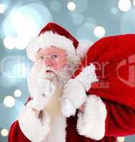 Composite image of santa claus carrying sack