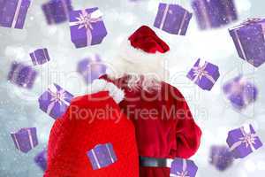 Composite image of santa claus carrying sack