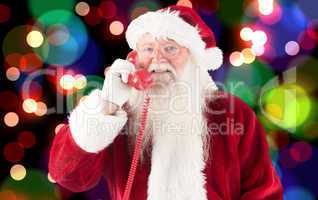 Composite image of santa claus on the phone