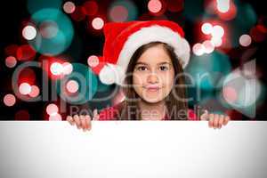 Composite image of festive little girl showing card