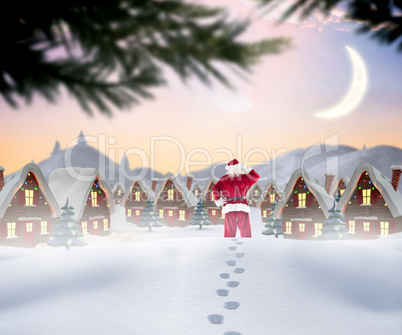 Composite image of santa walking in the snow