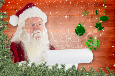 Composite image of santa claus checking his list